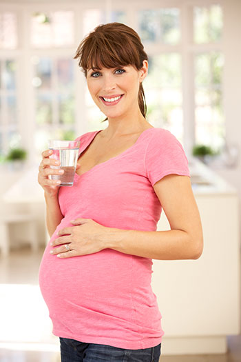 pregnant woman drinking water