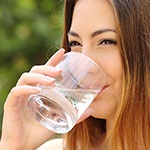 woman drinks a glass of reverse osmosis water