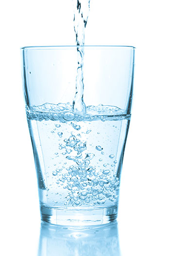 water from a Reverse osmosis system pouring into glass.